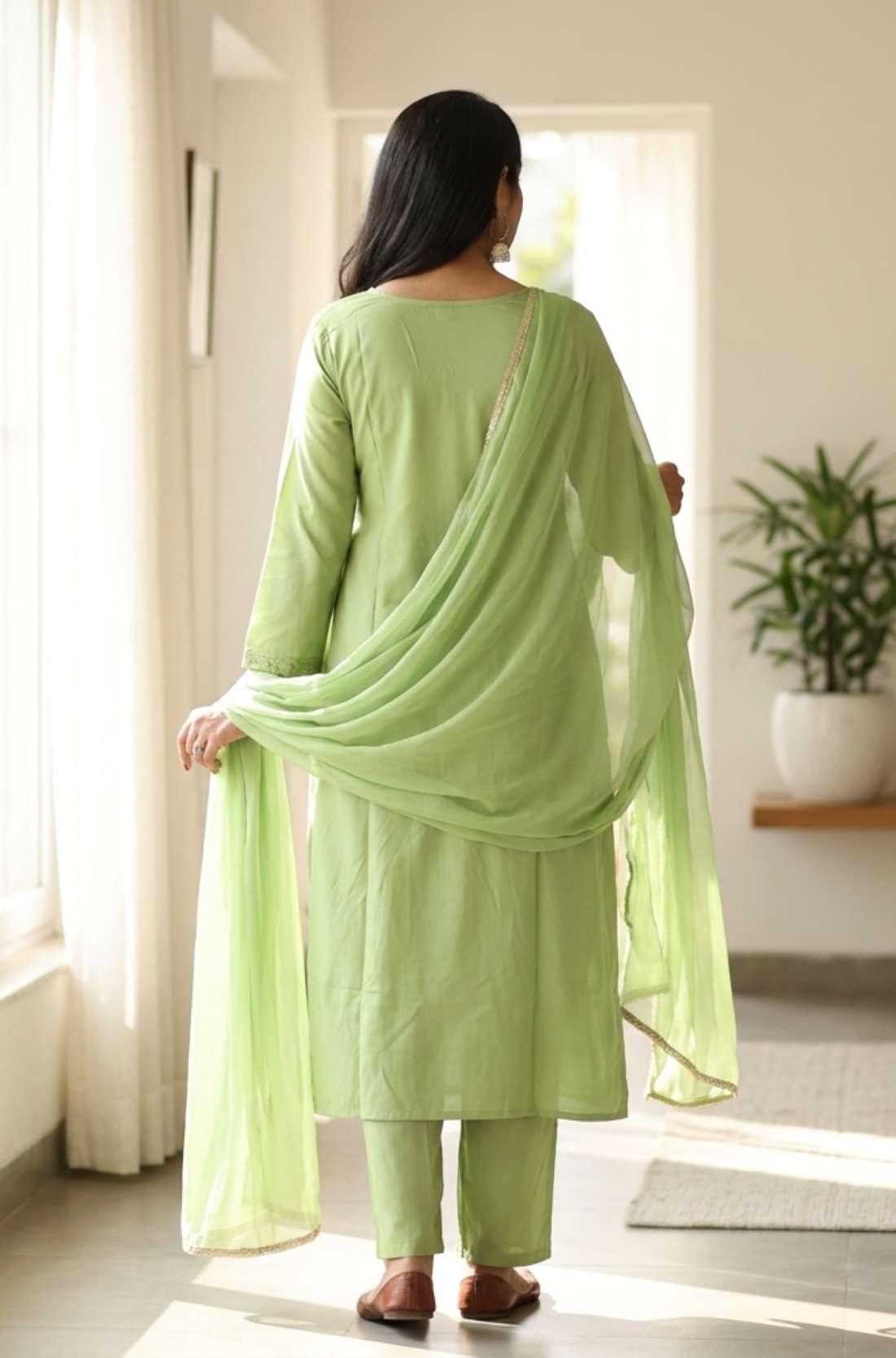 Back view of the straight fit light green embroidered kurta set showing the matching trousers and printed dupatta drape over the shoulder