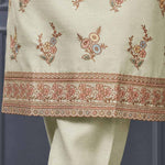 Close-up of floral embroidery and decorative scalloped border on a light green silk blend kurta for women.