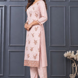 Side view of women’s light pink embroidered silk blend kurta set with matching pants.