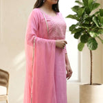 Side profile view of a model in a light pink embroidered salwar suit showcasing the side slit and elegant dupatta drape