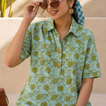Close-up of mint green hand block print cotton shirt showing floral pattern, wooden buttons, and front design details.