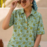 Close-up of mint green hand block print cotton shirt showing floral pattern, wooden buttons, and front design details.