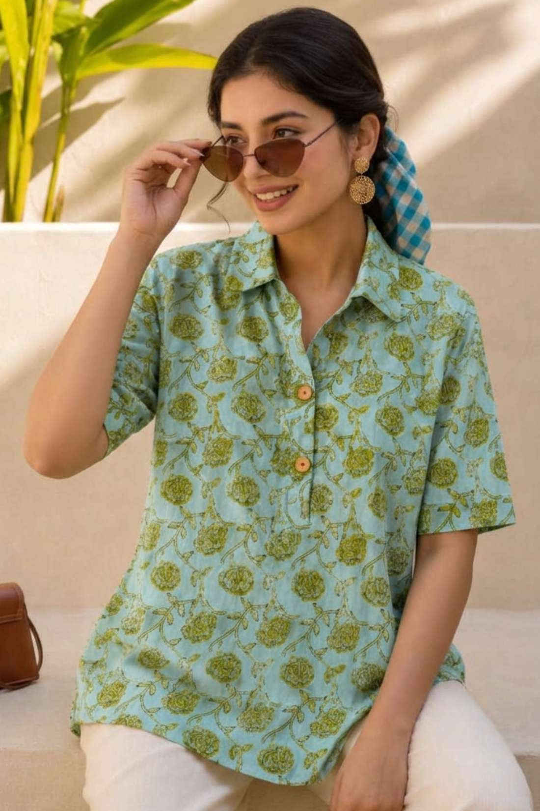 Close-up of mint green hand block print cotton shirt showing floral pattern, wooden buttons, and front design details.