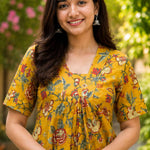 Detailed close-up of the front bodice highlighting the overlapping V-neckline cut and centered pleat gathering on an ochre yellow floral printed cotton kurti dress.