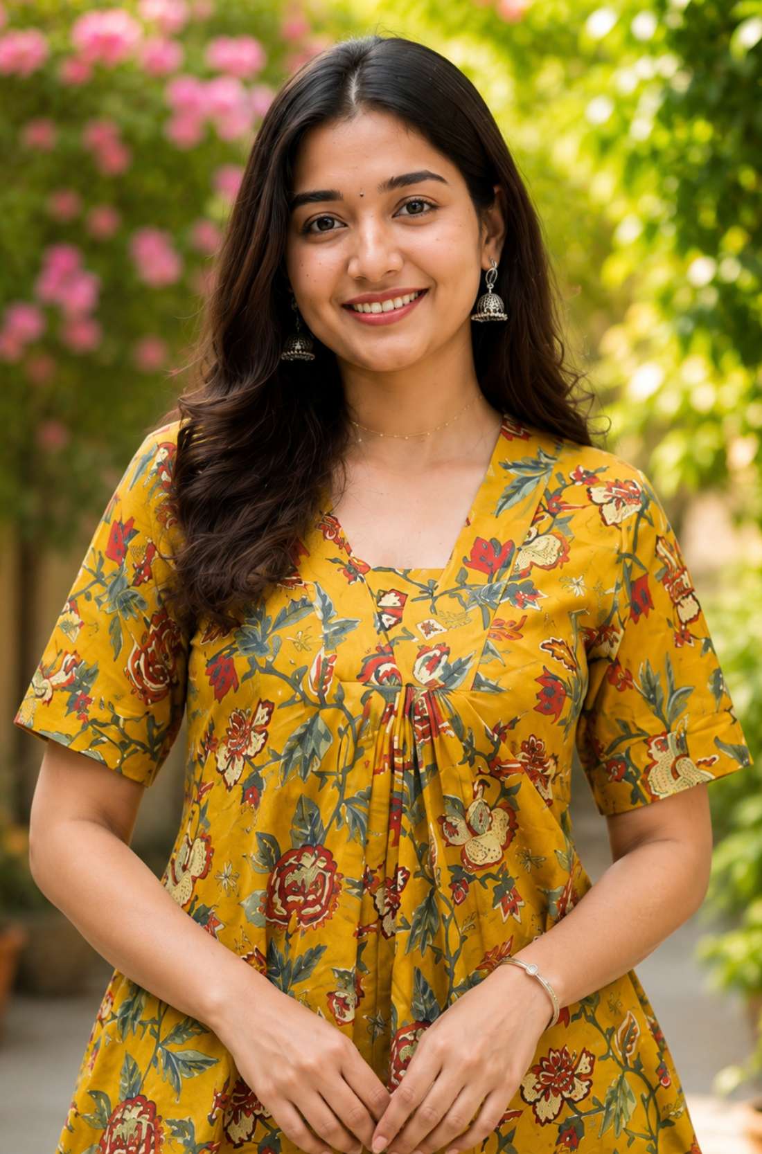 Detailed close-up of the front bodice highlighting the overlapping V-neckline cut and centered pleat gathering on an ochre yellow floral printed cotton kurti dress.