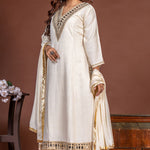 Off white Vatican Silk A-line kurta set for women, angled front view with mirror work, straight pants and chiffon dupatta