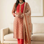 Left side angled view of a woman posing in a luxurious cream pashmina silk kurta set paired with an elegant dupatta