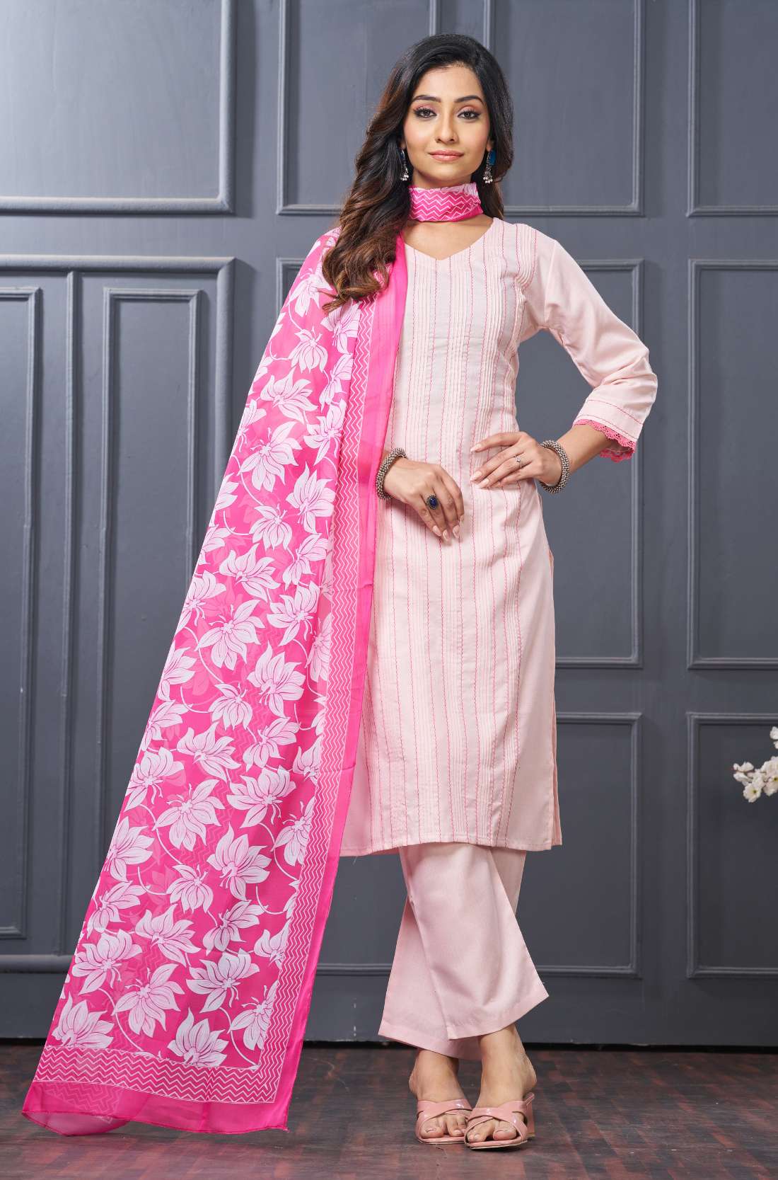 Front profile view of a model in a pink cotton ethnic kurta set displaying the straight-cut pants silhouette and the beautiful pattern of the draped matching dupatta