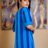Model looking over her shoulder showing the back and side profile of the Philippine blue striped pure handloom cotton tunic dress.