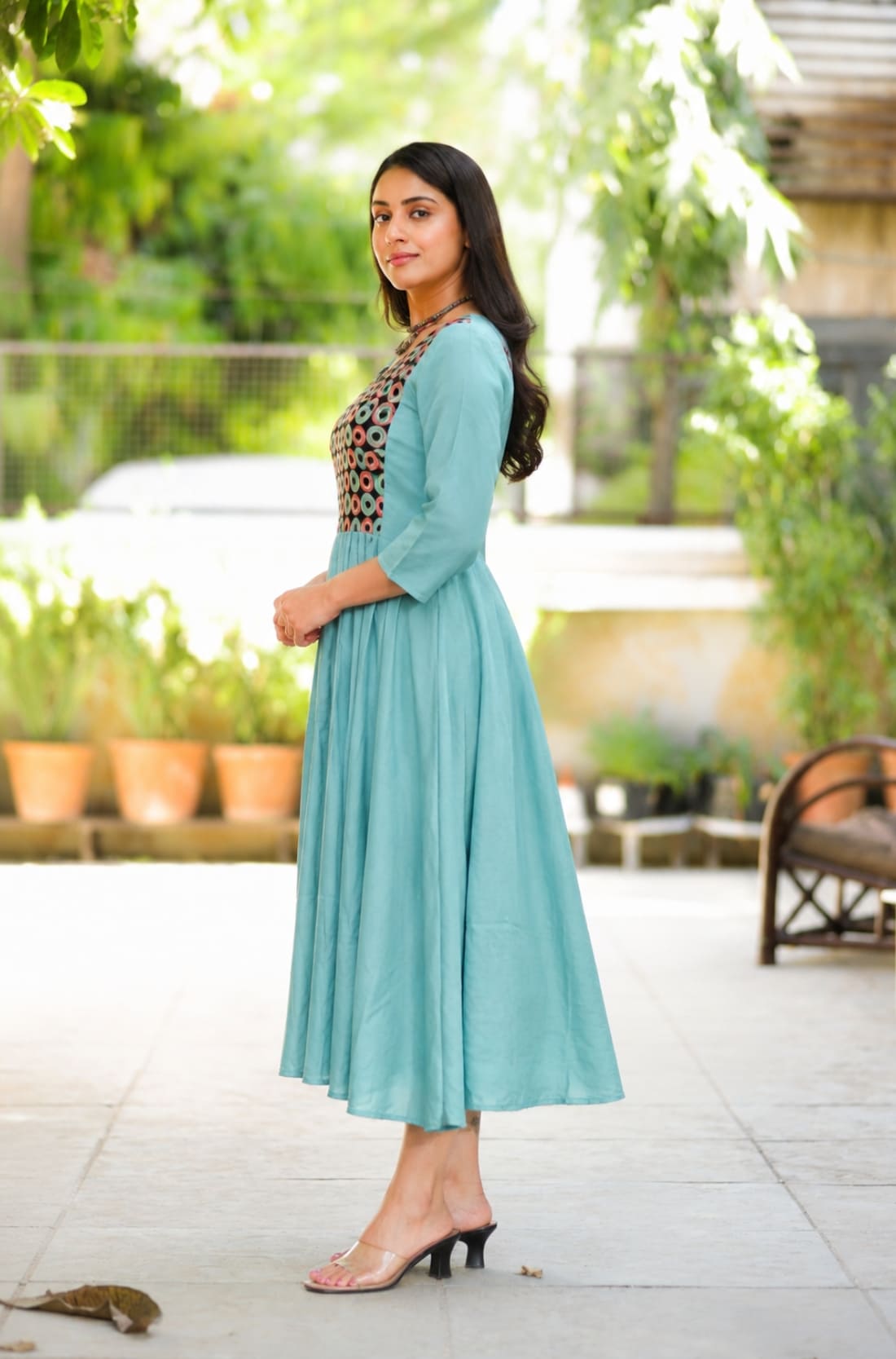 Side view of sea green A-line flared kurti with 3/4 sleeves and calf-length design