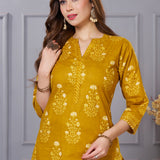 Close up view of the V neckline design showcasing white lace inserts and contrasting border details on the ochre yellow floral printed cotton kurta