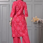 Back view of the rani pink straight fit floral cotton kurta set highlighting the print continuation and the dupatta drape