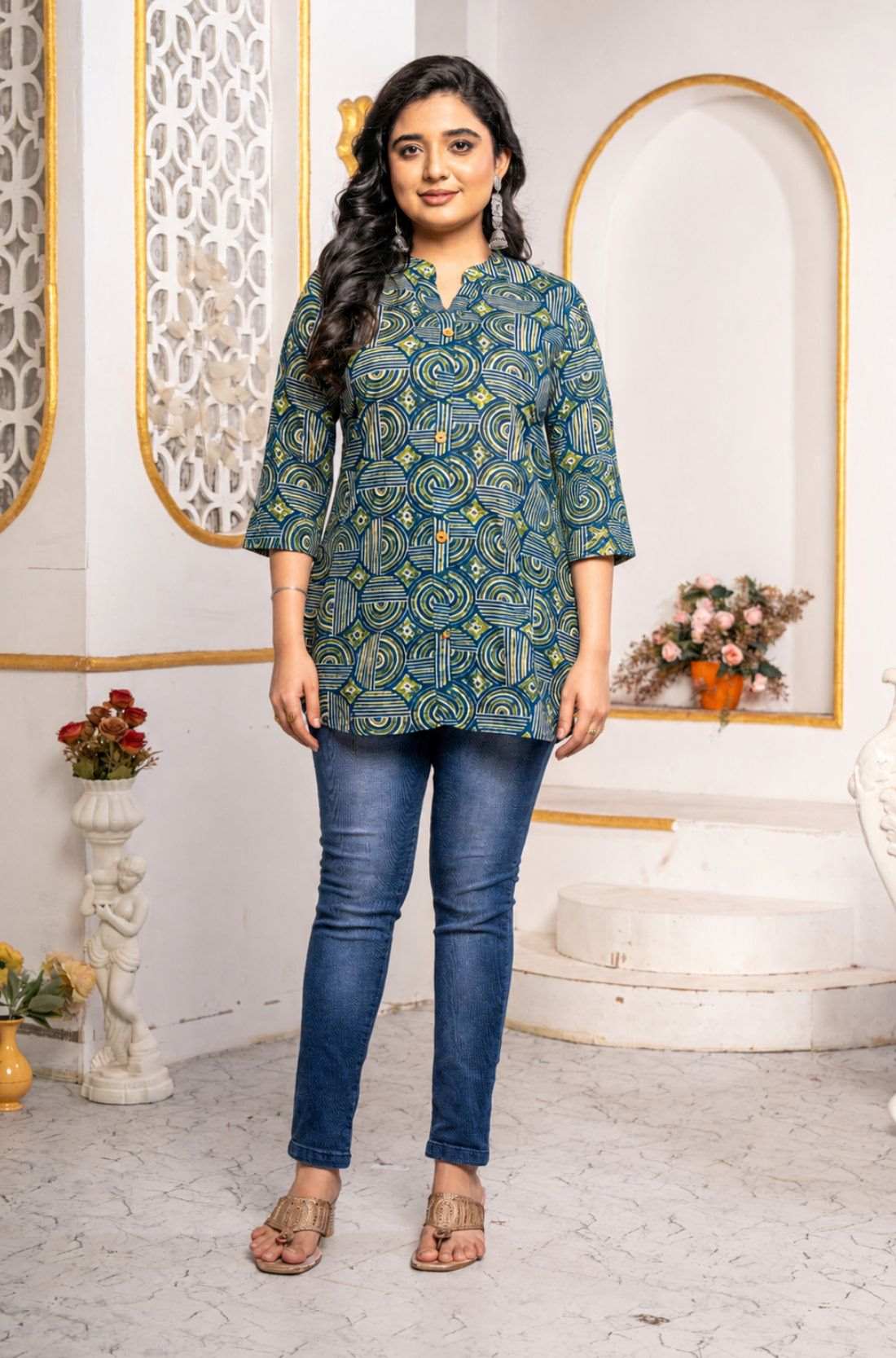 Women's Geometric Hand Block Print Pure Cotton Shirt Style Kurti in blue and olive green featuring a stand collar, wooden button placket, 3/4 sleeves, and a relaxed hip-covering silhouette paired with blue jeans.