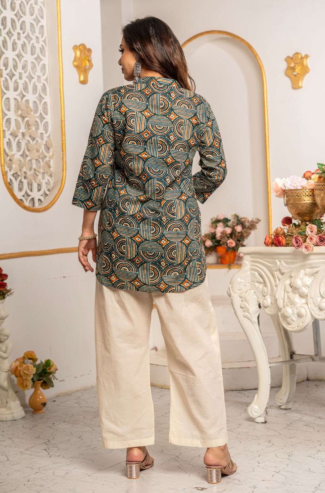 Back view of Women's Geometric Hand Block Print Pure Cotton Shirt Style Kurti in forest green and rust orange displaying an all-over handcrafted geometric block print and hip-covering silhouette.