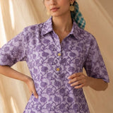 Front close-up of a women's lavender floral hand block print cotton shirt with wooden buttons and classic collar.