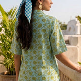 Back View
Back view of a women's mint green block print cotton shirt featuring short sleeves and curved hem.