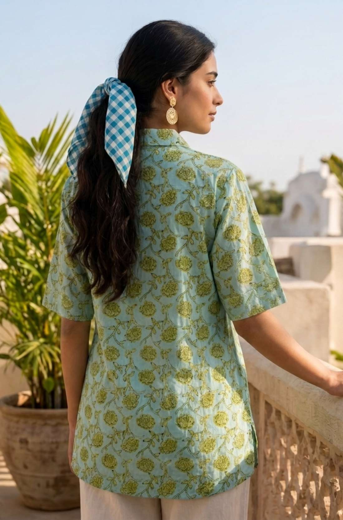 Back View
Back view of a women's mint green block print cotton shirt featuring short sleeves and curved hem.