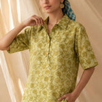 Front view of a women's yellow hand block print cotton shirt with wooden buttons and short sleeves.