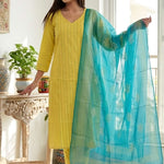 A smiling woman wearing a stylish yellow pure cotton thread embroidered kurta set with a matching printed dupatta