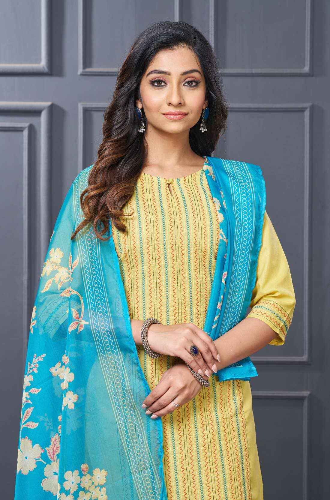Close-up of embroidery detail on yellow cotton kurta