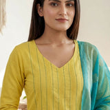 Detailed close-up shot of a bright yellow pure cotton kurta showcasing elegant vertical pintuck detailing with contrast green stitching along the V-neckline, styled with a contrasting turquoise blue dupatta.